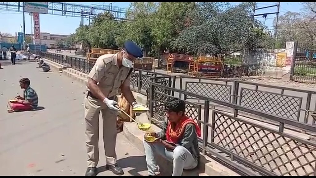 RPF officials providing Food to Poor RPF Distributing food to poor People